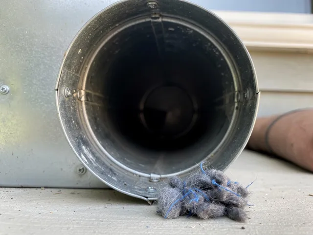 Wolcott Dryer Vent Cleaning technician using specialized equipment to clear severe dryer vent blockage in Wolcott